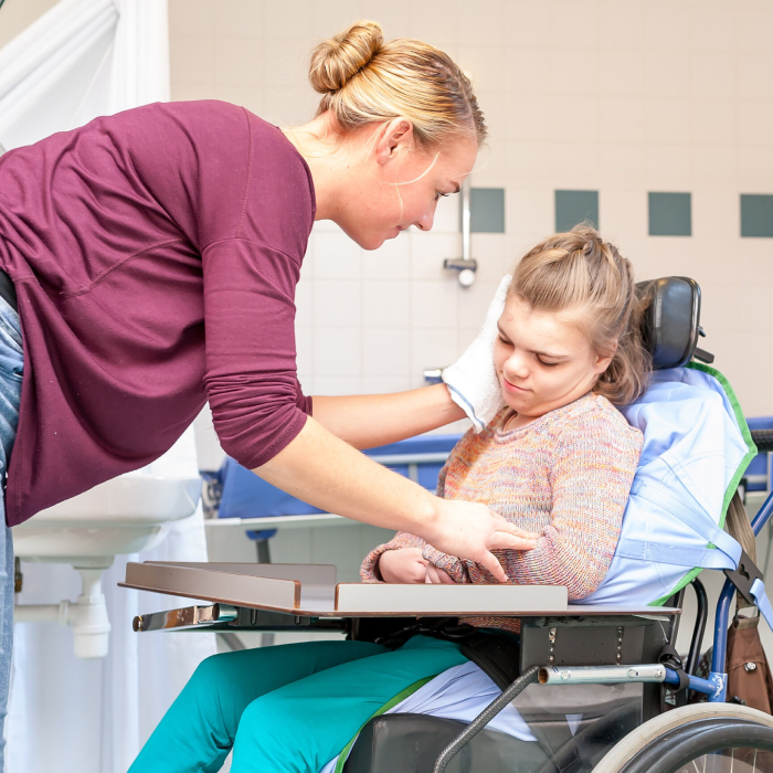 Personal Care Provider assisting a young girl with daily care support