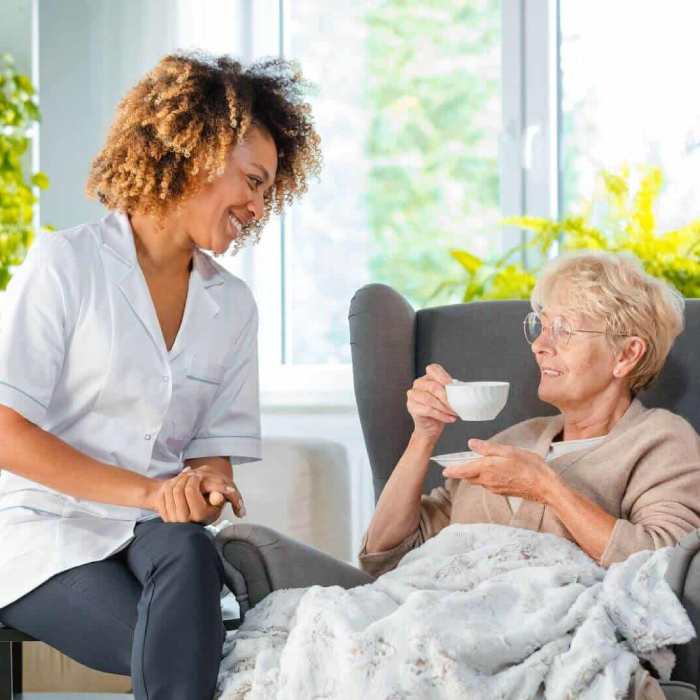 Personal Care Provider offering compassionate support to an elderly woman