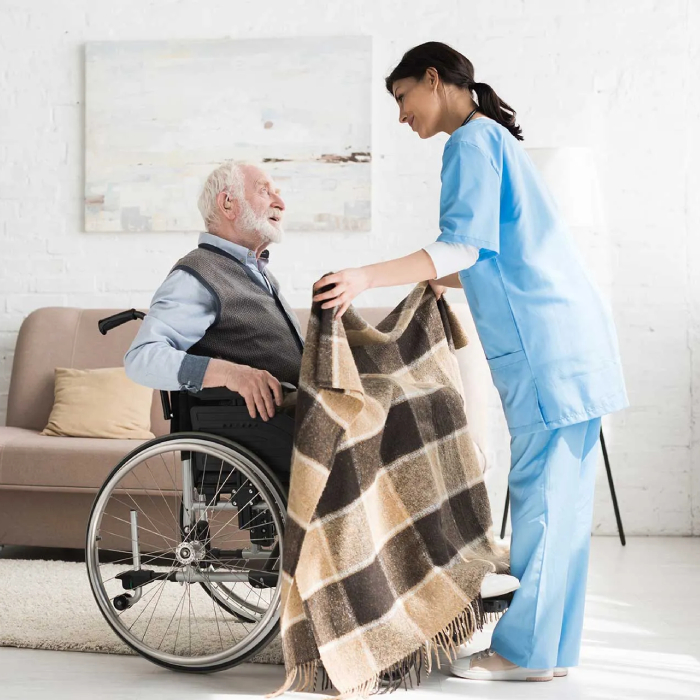 Nursing services NDIS - Caregiver assisting elderly man in wheelchair