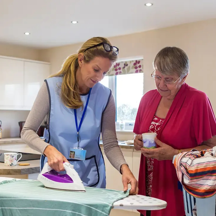 NDIS Household Tasks – Support worker assisting with ironing at home