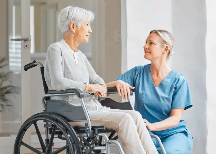 NDIS Household Tasks - Caregiver assisting elderly woman in wheelchair